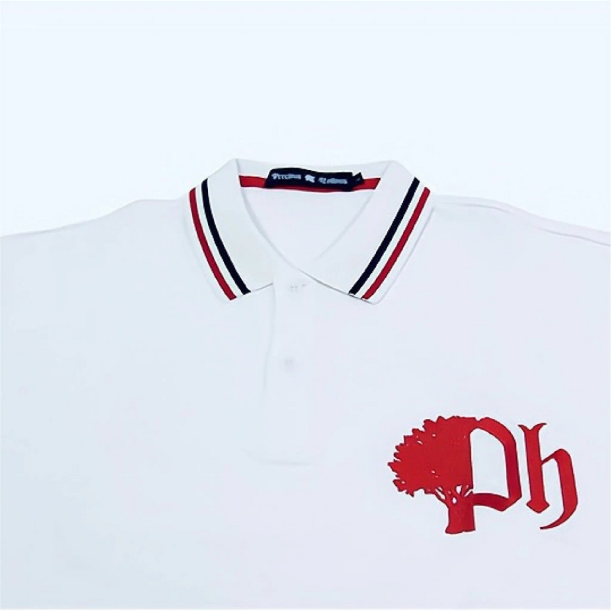White cotton polo with red and navy blue and red striped collar, featuring red logo on the chest.#color_white