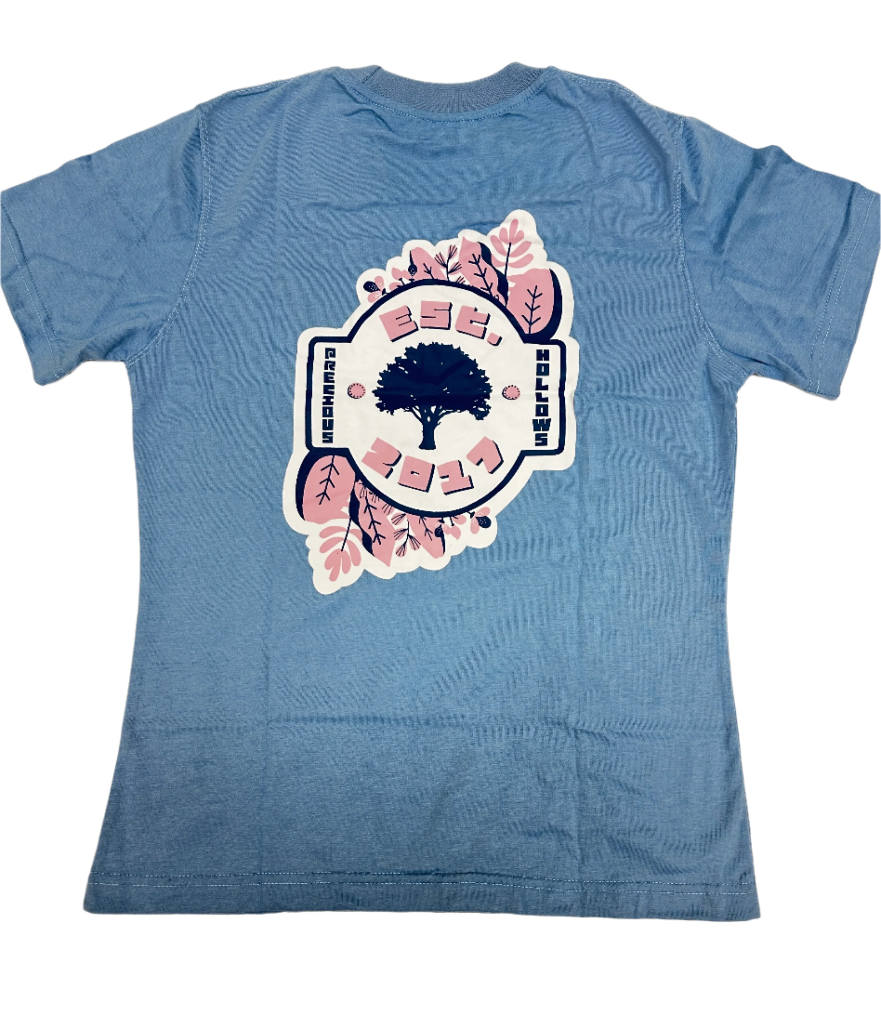 Blue t-shirt with a graphic design on a beige background.