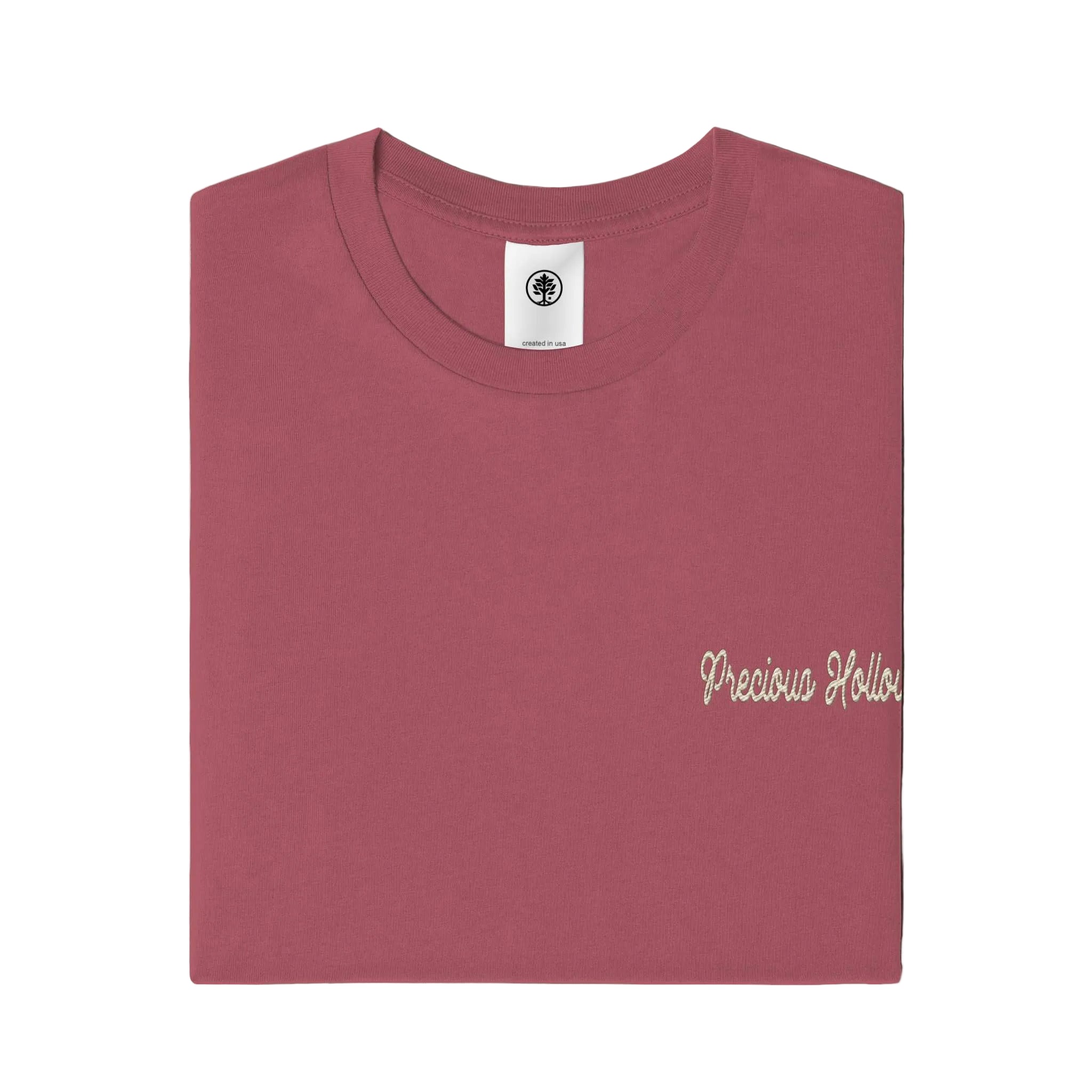 Folded maroon t-shirt with 'Precious Hollows' text on a white background