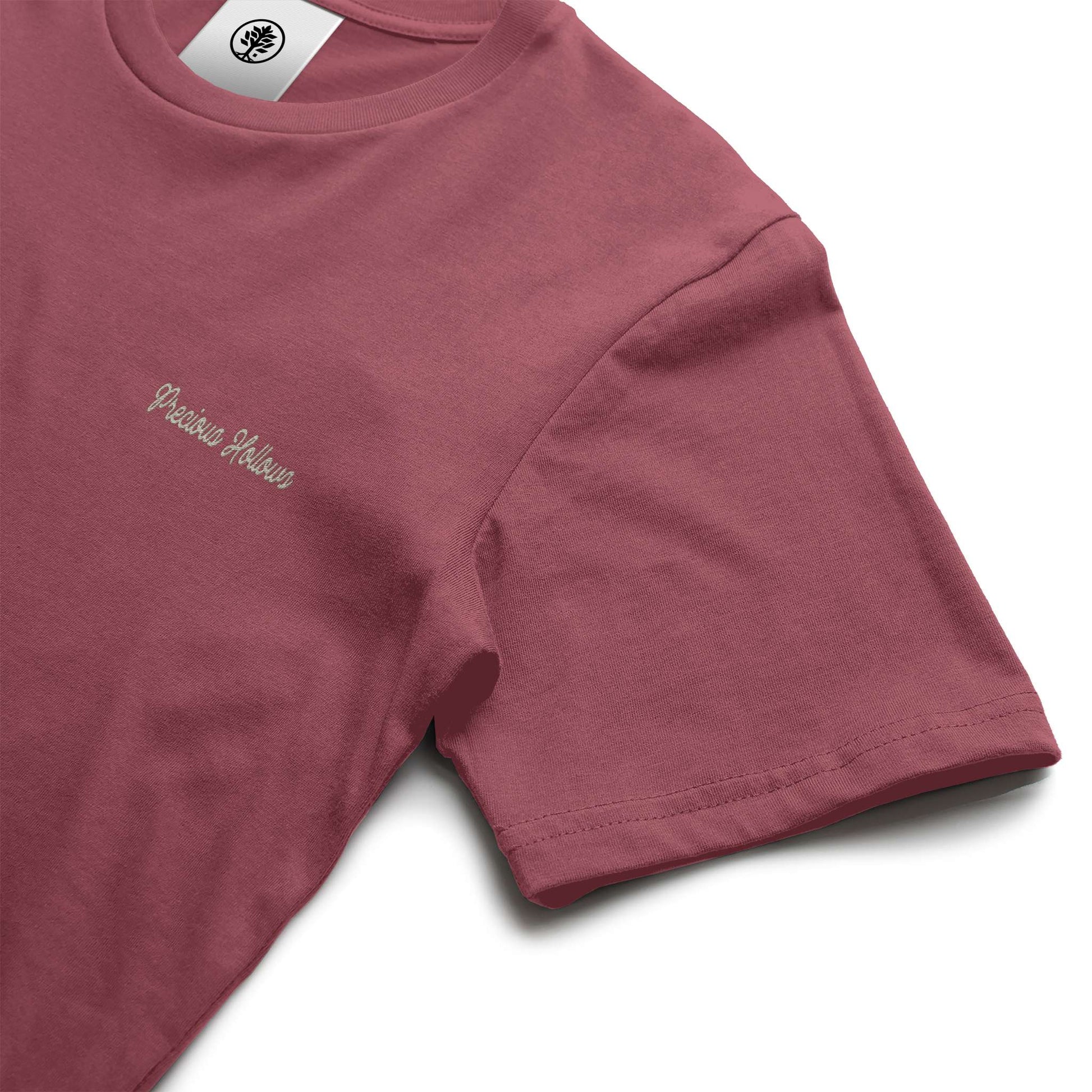 Maroon t-shirt with a small logo on a white background