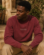 Lifestyle view of the Private Stock Crewneck in a sunlit courtyard