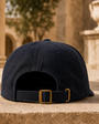 Navy Signature Script Cap product view on a stone ledge