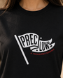 Close view of the pennant graphic on the black Standard Tee
