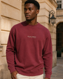 Model wearing the Private Stock Crewneck in a warm stone courtyard