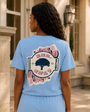 Model wearing the sky blue Weekend Resort Set by a stone courtyard