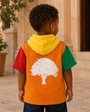 Child wearing the Mini Block Hoodie in a stone courtyard