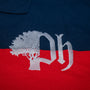 Close-up of a logo on a navy blue and red fabric.#color_navy-stripes