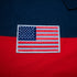 American flag patch on navy blue and red fabric.#color_navy-stripes