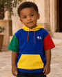 Child wearing the Precious Hollows Mini Block Hoodie in a courtyard