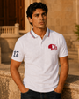 Model wearing the white Club Tipped Polo at golden hour
