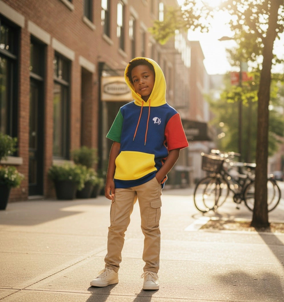 Child wearing a colorful hoodie on a city street