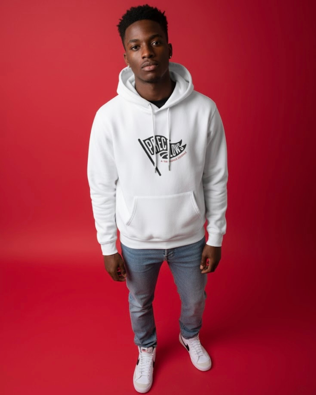 Person wearing a white hoodie with a logo on a red background