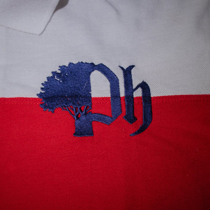 Close-up of a logo on a polo shirt with striped red and white fabric. 