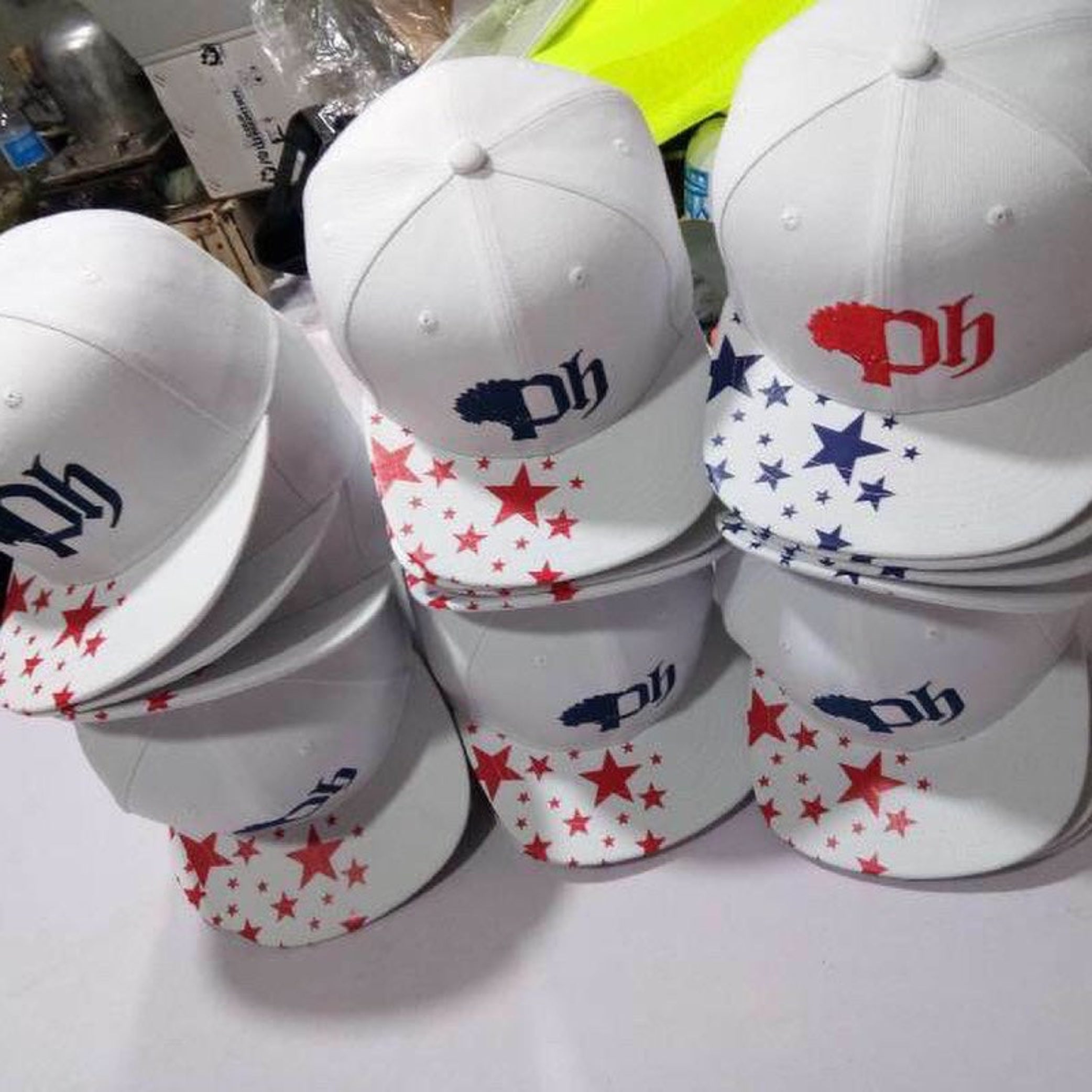 White caps with various designs and logos on a white surface