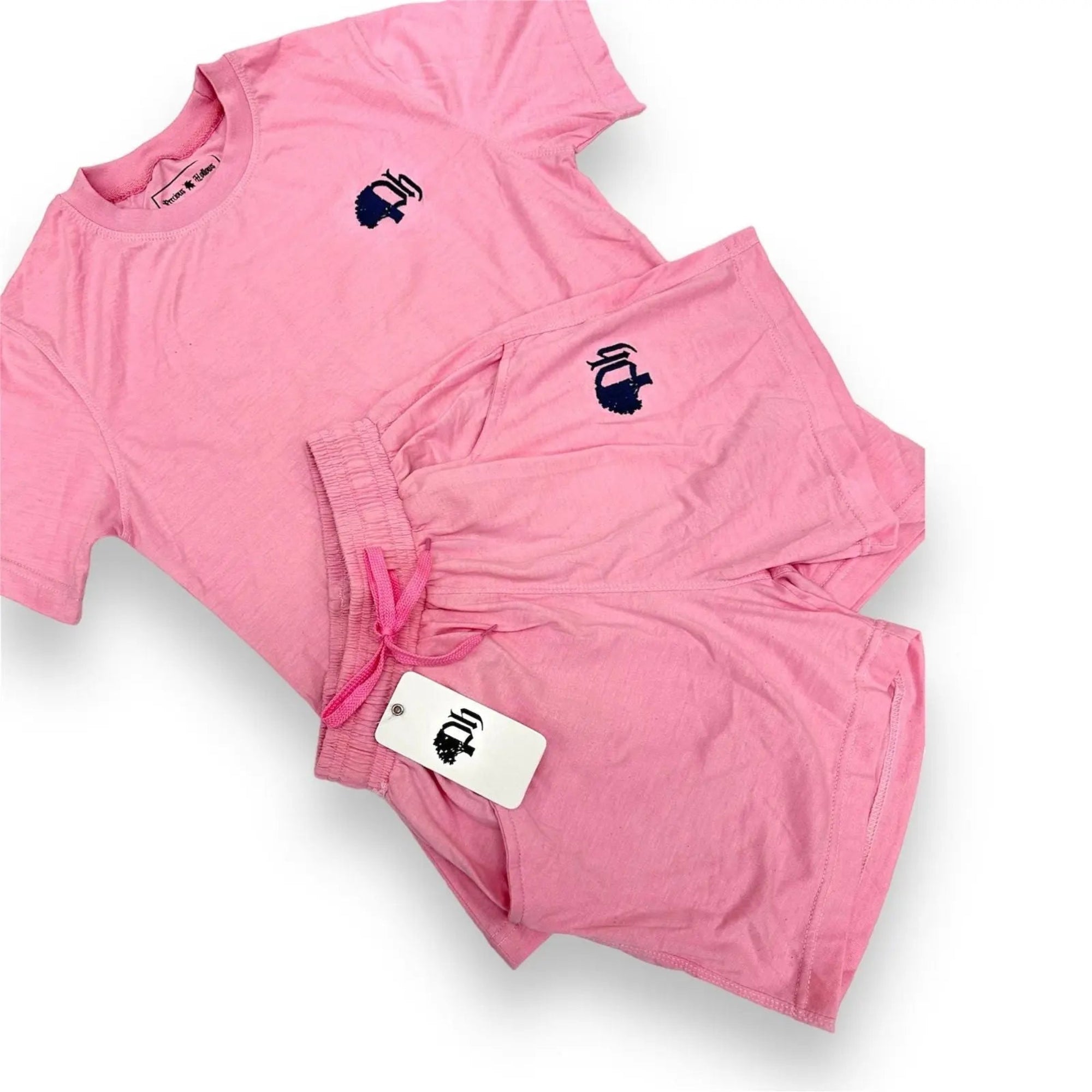 A set of women's clothing including a pink t-shirt and pink shorts, both featuring a small logo.#color_pink