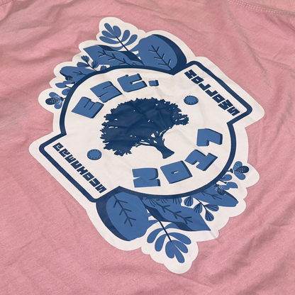 Blue and white logo on a pink shirt.