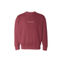 Maroon sweatshirt with a logo on the chest against a white background