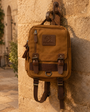 Precious Hollows Weekend Carryall on a rustic stone wall