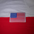 American flag patch on a red and white fabric.#color_white-stripes