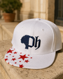 White Fieldhouse Snapback on a sunlit stone ledge