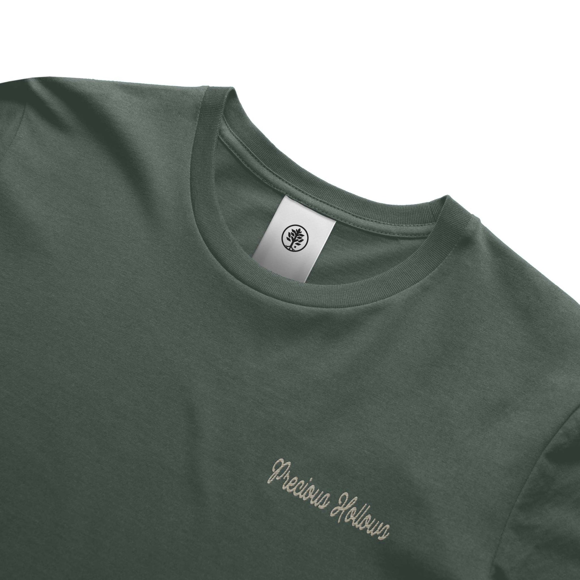 Green t-shirt with 'Precious Hollows' embroidery and a brand label on a white background